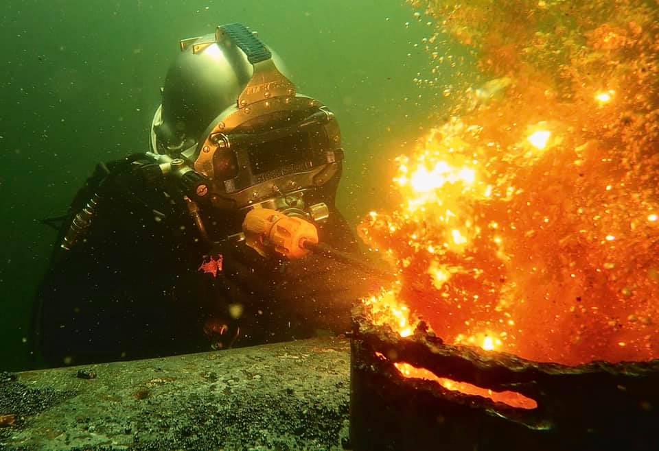 An underwater welder performing a wet weld