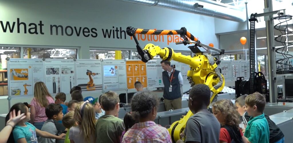 An elementary class being given a demonstration with an educational robot