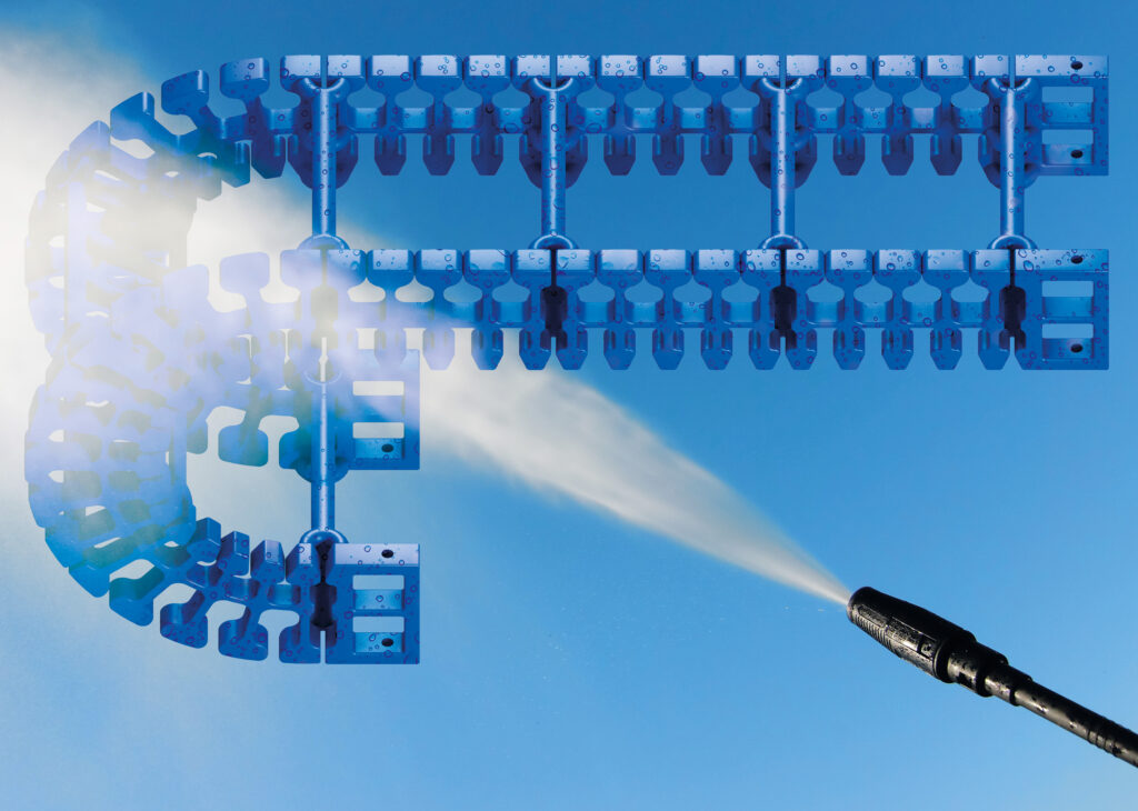 An FDA-compliant TH3 cable carrier being washed down over a blue gradient background