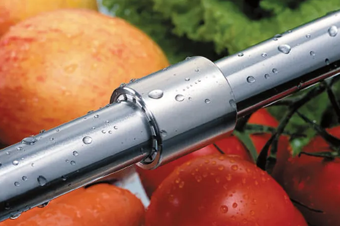 An FDA-compliant drylin bearing in the foreground with various foods in the background
