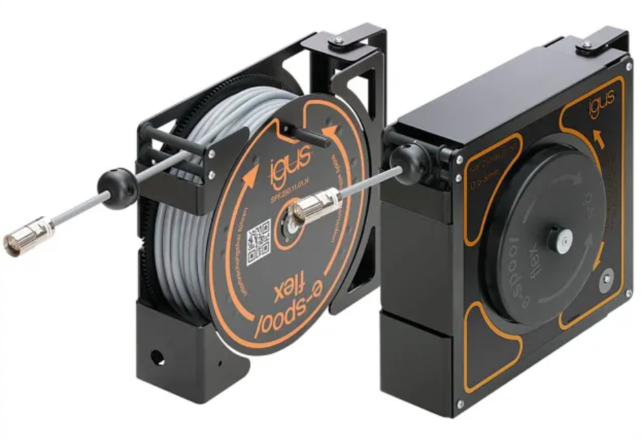 Two igus e-spool flex cable reels side by side: one open, showing a gray cable wound on the spool with connectors at both ends, and one enclosed in a black housing