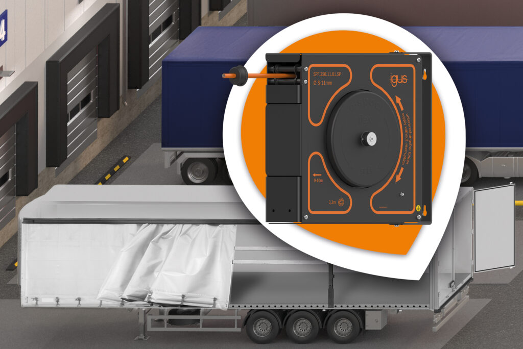 Enclosed igus e-spool flex cable reel in an orange and white circular callout over a rendering of a truck trailer at a loading dock, with an orange cable exiting the housing.